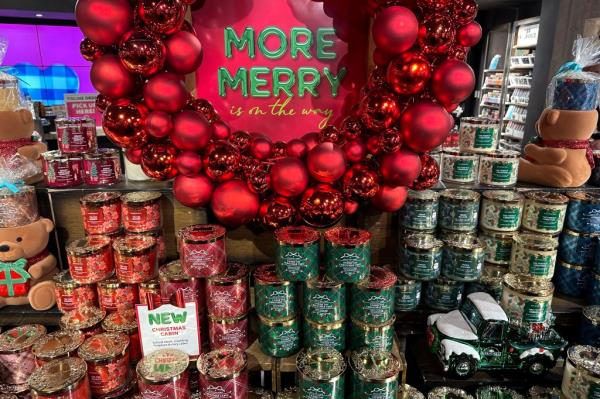 Arrangement of holiday-themed candles at Bath and Body Works store.