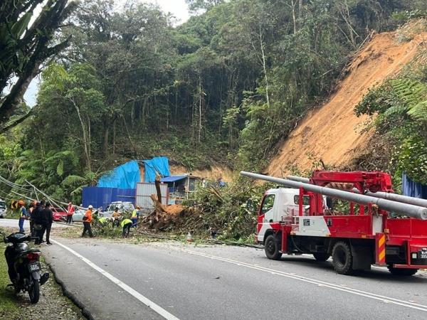 Landslide hits Jalan Brinchang in Cameron Highlands, road blocked, vehicle crushed by fallen pole, no casualties reported