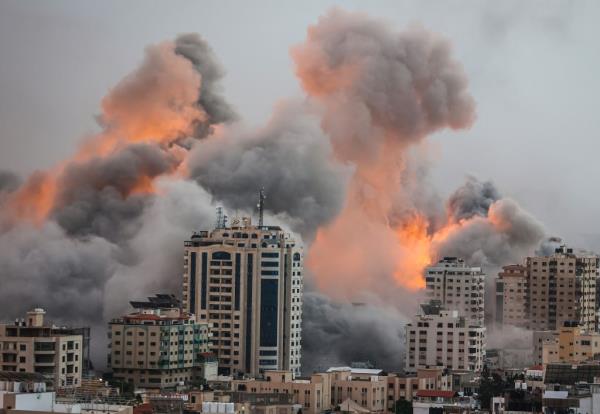 Flames and smoke billow out of buildings in Gaza following Israeli airstrikes.